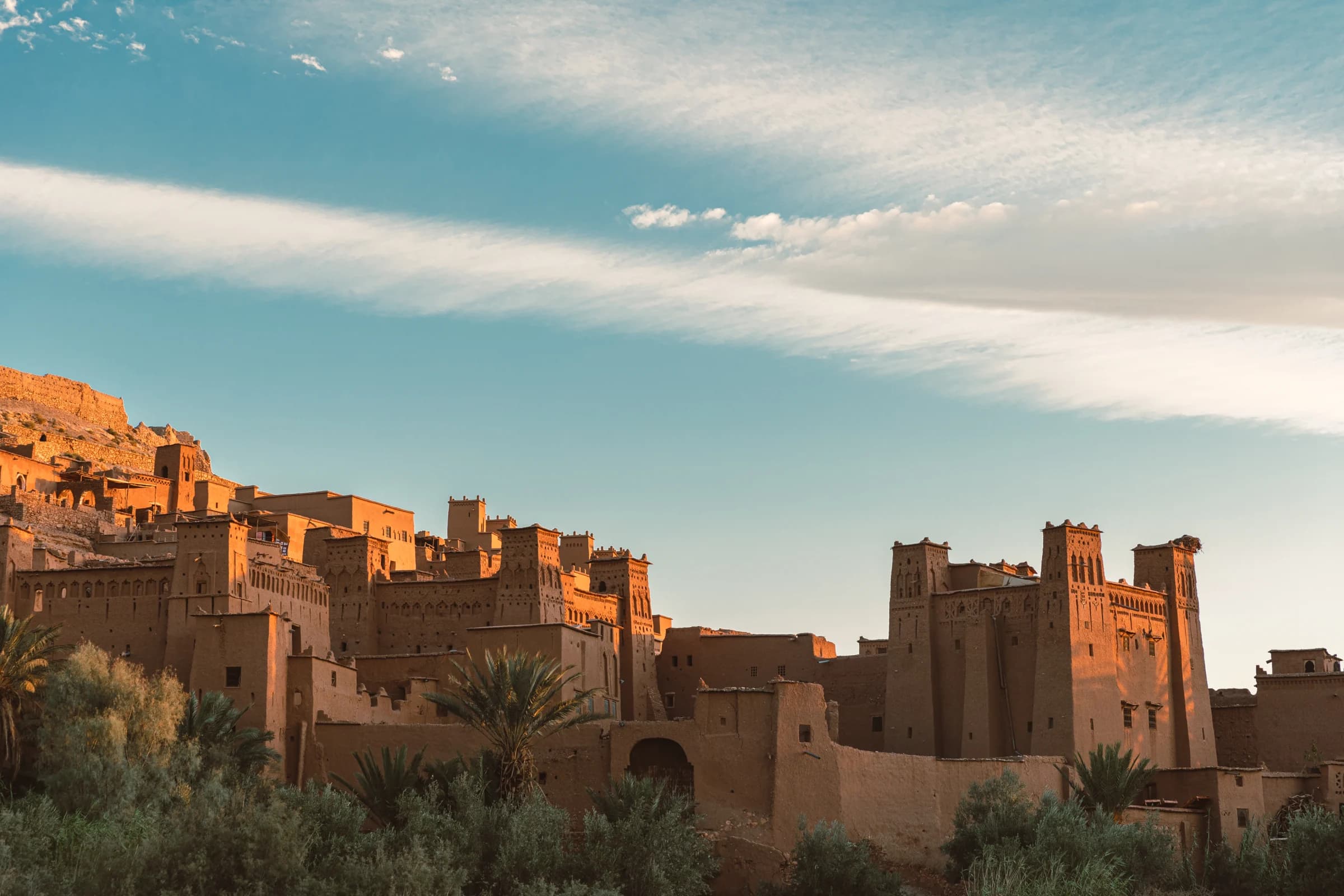 Earthen architecture at Aït Benhaddou beneath a wide blue sky